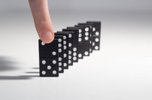 This photo, “Human hand ready to push a row of dominoes” (source: https://www.flickr.com/photos/30478819@N08/38280957094) is copyright © 2017 Marco Verch and made available under a Attribution 2.0 Generic (CC BY 2.0) license: https://creativecommons.org/licenses/by/2.0/legalcode